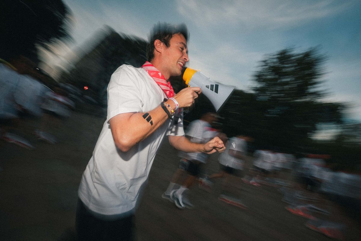 A run leader with a megaphone moving alongside the group