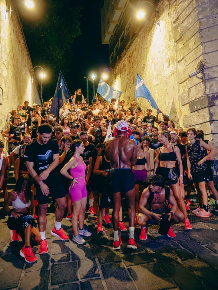 Runners gathered on the steps after the run, many in the red test shoes