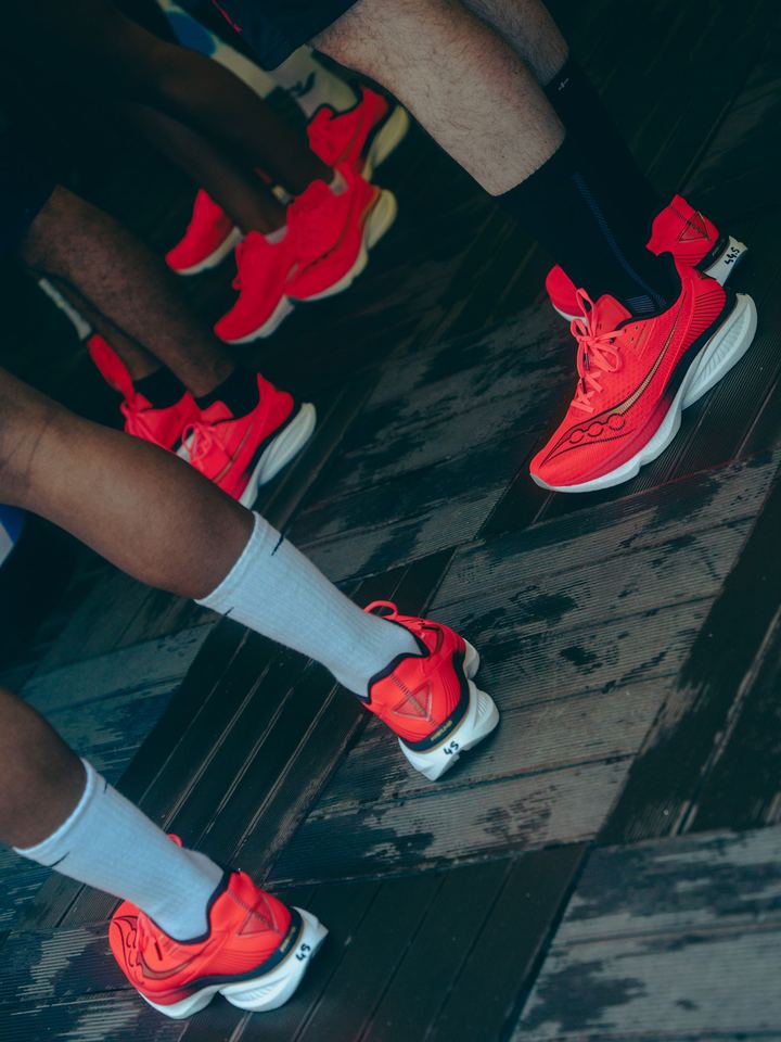 Close-up of runners wearing the red Saucony test shoes